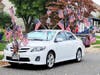 Sanders white sedan decorated with material reaching more than 10 feet high.