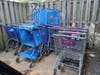 Several shopping carts are being housed in a dumpster enclosure at Leesburg Apartments.