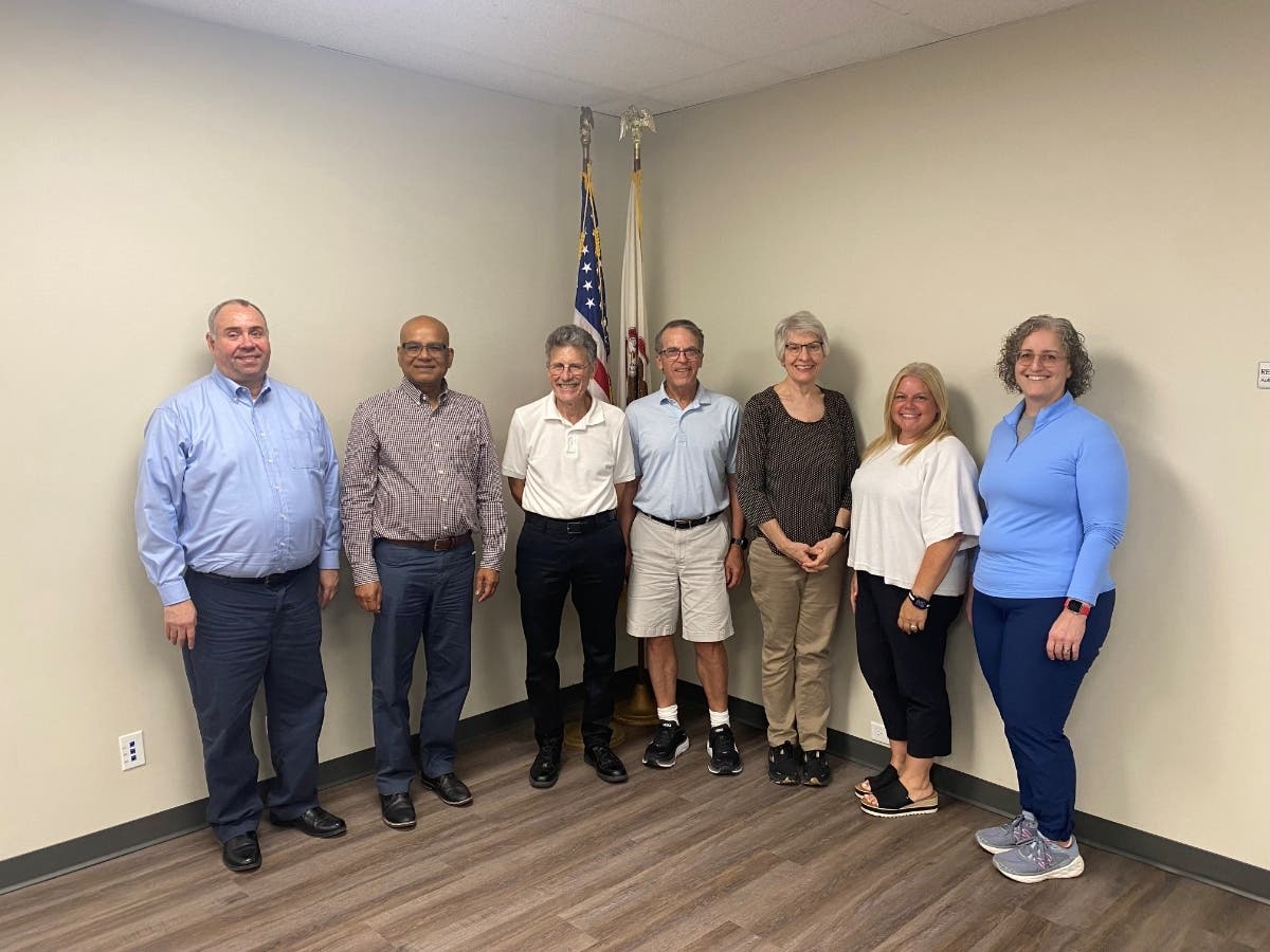 Pictured from left to right are Phil Hirsh, Akrom Hossain, Al Dorfman, Mike Garfield, Sally Thoren, Carolyn Lewis, and Noelle Moore.