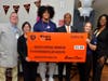 Chicago Bears defensive lineman Daniel Hardy and teammates pose with a check on Tuesday, October 29, 2024, at Advocate Sherman Hospital in Elgin, Illinois. The donation from Bears Care will help with breast cancer education efforts.