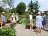 Joyful attendees touring a garden last year