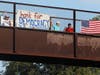 Two Glenview residents and three Morton Grove residents displayed large banners and waved small American flags from Cook County Forest Preserve Bridge on Friday. 