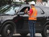 A Metro worker talks with the Glenview Police at Glenview Road crossing