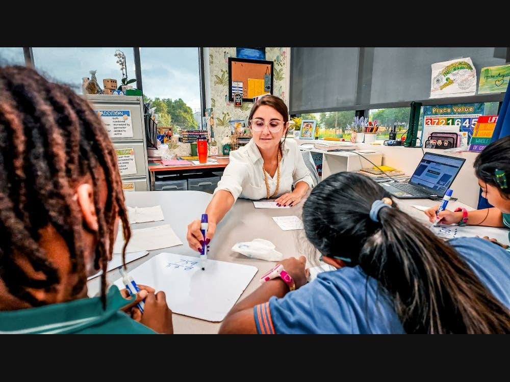 A Harmony teacher engages students in group instruction