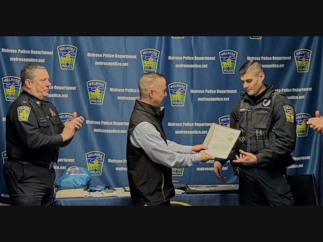 From left, Lt. Paul Norton applauds as Chief Kevin Faller presents Officer Jake Karelas with a Letter of Commendation for saving two cats from a house fire on Jan. 31.