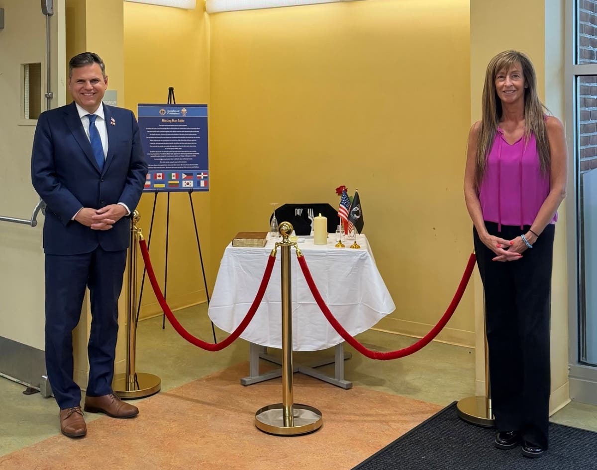 Mayor Gary Christenson (left) and Health and Human Services Director Laura Vlasuk unveil the display.