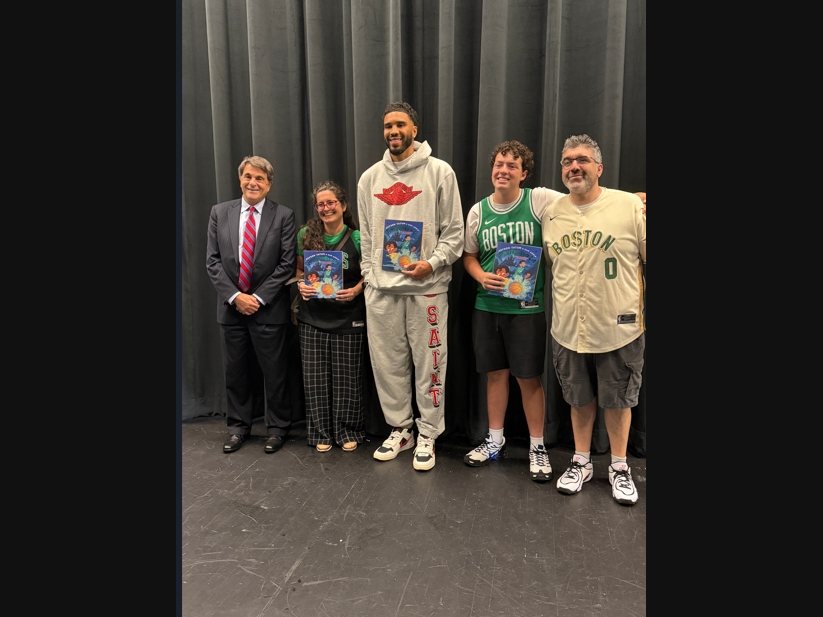 Tatum (center) met with city and district leaders as he shared his newest story with Newotn youth.