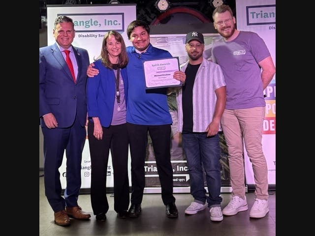 Malden Mayor Gary Christenson, Triangle, Inc. CEO Rachel Kaprielian, Prism Program winner Michael, and Prism staff members David and Travis. Triangle’s Prism Program provides critical support services for autistic young adults.