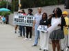ICC CEO, Hazel Applewhite, rallies the crowd while Director of Programs, Charles Barlow-Richardson, and Director of Family Services, Rosanna Eve, stand by in support.
