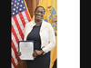 Hazel Applewhite holding newly signed Commissioner's letter.