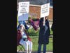 Two un-identified ladies who proudly call themselves "Old Hippies," displayed vivid signs to show their displeasure with Donald Trump policies.