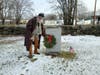 Placing a wreath at Jude Hall's stone