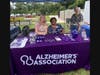Ashley Mittelmeier, Erica Holmes, and Kim Roman from the Alzheimer’s Association welcome guests at the Education Table.