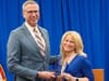 Richards teacher Christina Kreil accepts the Outstanding Achievement in Sportsmanship Award from Illinois State Treasurer Michael Frerichs.