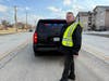 Richards SRO Mike Conroy stands in front of his patrol vehicle.