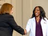 First-year dental hygiene student Kayla Proctor shakes hands with the dean. 