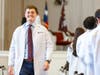 First-year dental student Bryce Pearson returns to his seat after donning his white coat. 