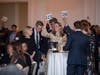 Give Thanks & Give Back Gala attendees participate in a live auction at the Fairmont Hotel Washington DC
