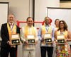Dr. Hong, second from left, presents the “Key to the Heart” to, from left, Dr. Bernard Fialkoff, Dr. Juan Tapia-Mendoza, and Dr. Hanette Gomez, D.D.S. The key symbolizes the important role an influential leader plays in shaping the world’s future.