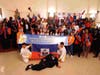 Attendees pose for a group photo holding Haitian flags and a banner celebrating the UN’s recent designation of July 12 as the International Day of Hope.