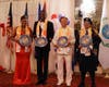 Dr. Hong, second from right, presents the Compass Clock of Conscience to three influential leaders in recognition of their positive contributions to society. The clock symbolizes the importance of conscience in guiding actions and decisions.