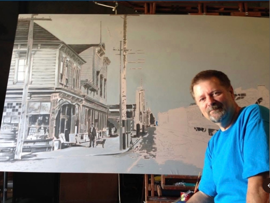 A photo of Dan Fontes with one of his art pieces.
