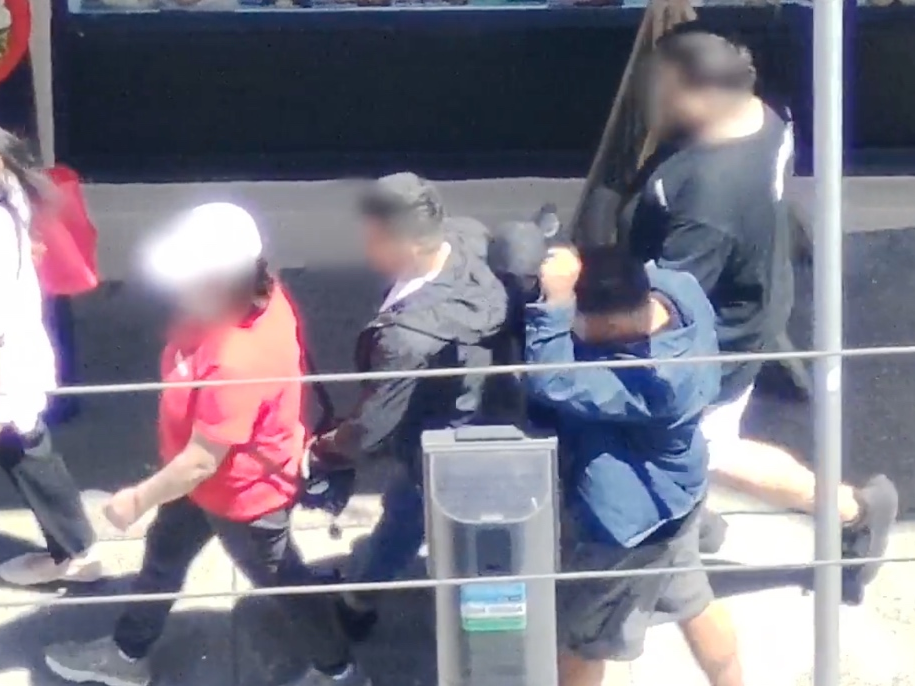 A suspect pickpockets a pedestrian in San Francisco's Chinatown.