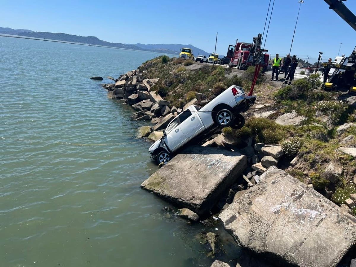 Authorities pull out a submerged truck from the Harbor Channel.