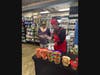 Longtime neighborhood customer Nancy Hidalgo receives a free sample during the reopening celebration. “Everything is always fresh,” she shared.