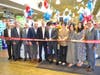 John and Alisa Sun prepare to cut the ceremonial ribbon, surrounded by Allegiance Retail Services team members and family, marking the Grand Reopening of Super Foodtown of Throggs Neck.