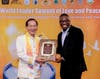 Dr. Hong presents the Distinguished Service Award for Love, Peace, and Hope to Rev. Dr. Bannister in recognition of his outstanding leadership in promoting love, peace, and hope for the benefit of humanity.