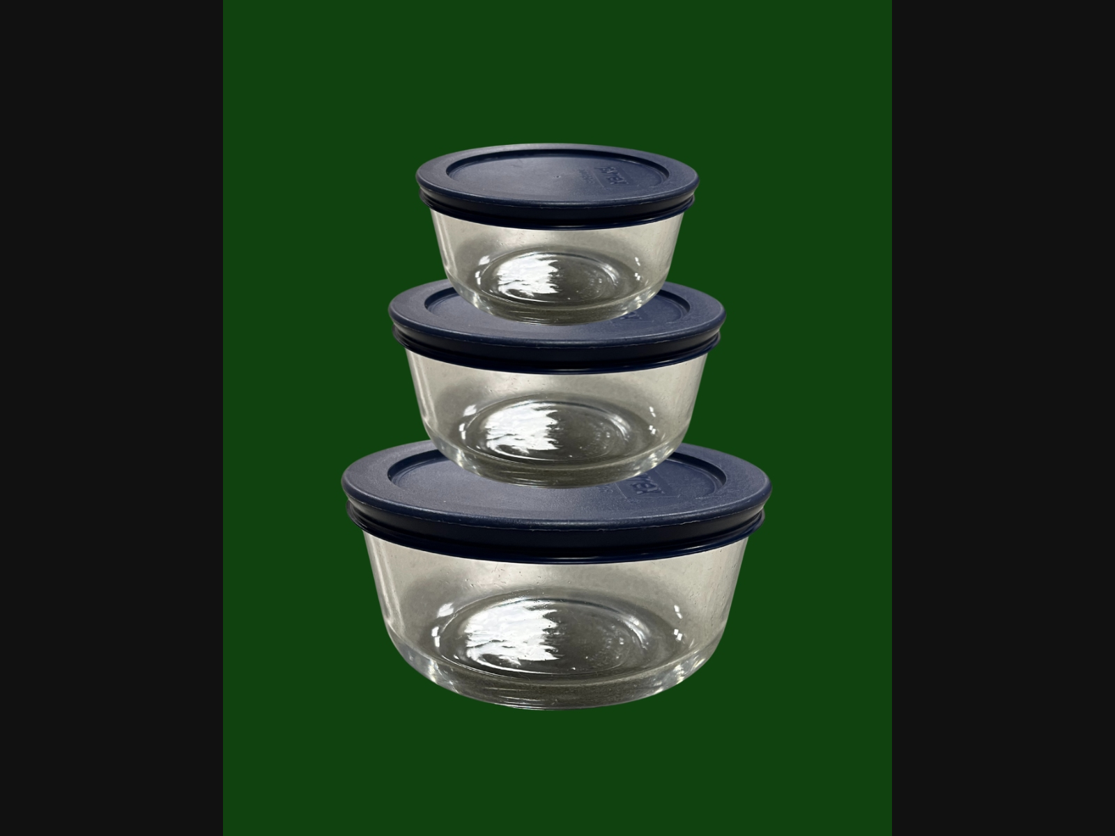 Three Pyrex glass food storage containers.