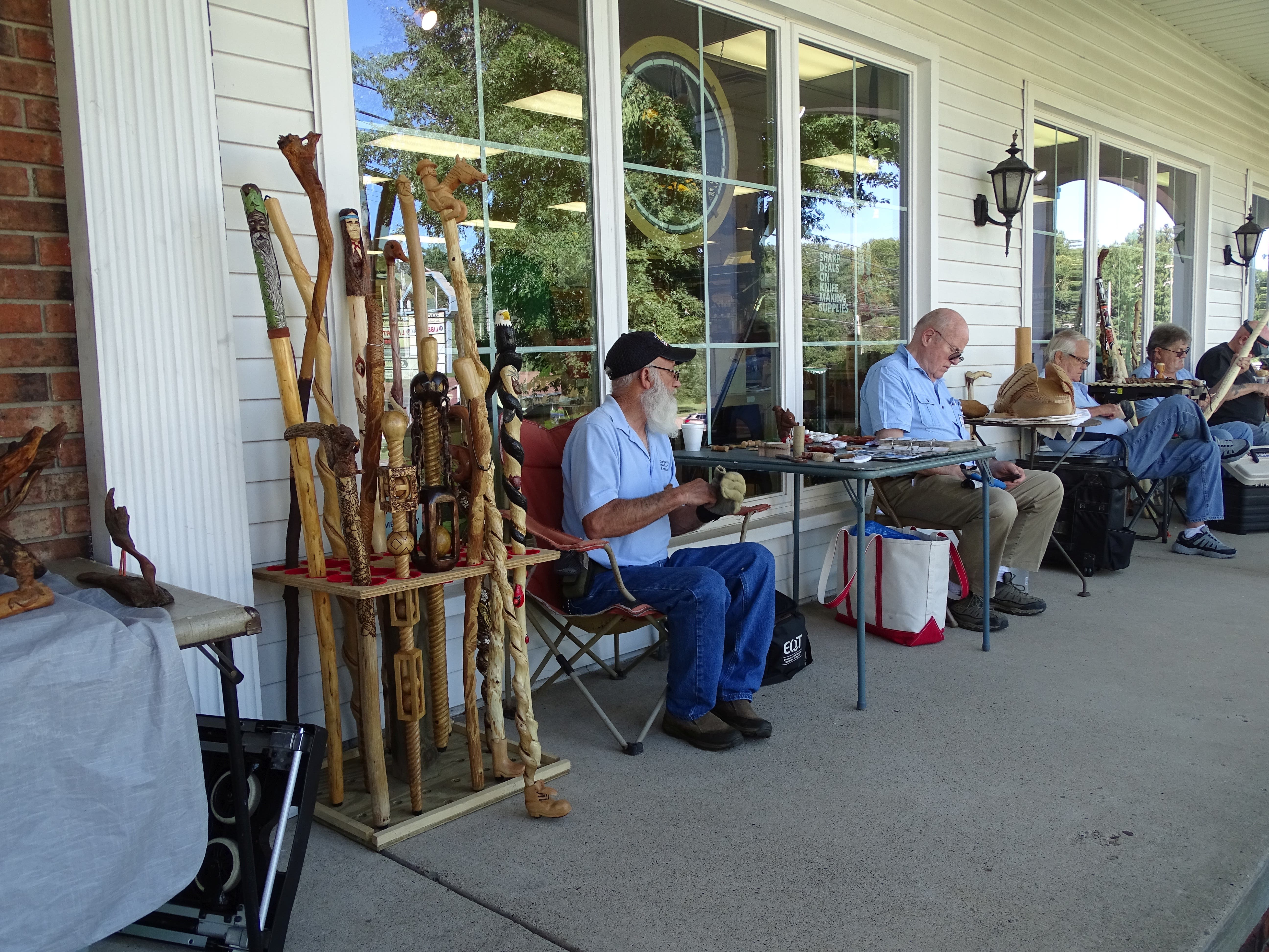 Geppetto Woodcarvers Carving on the Porch
