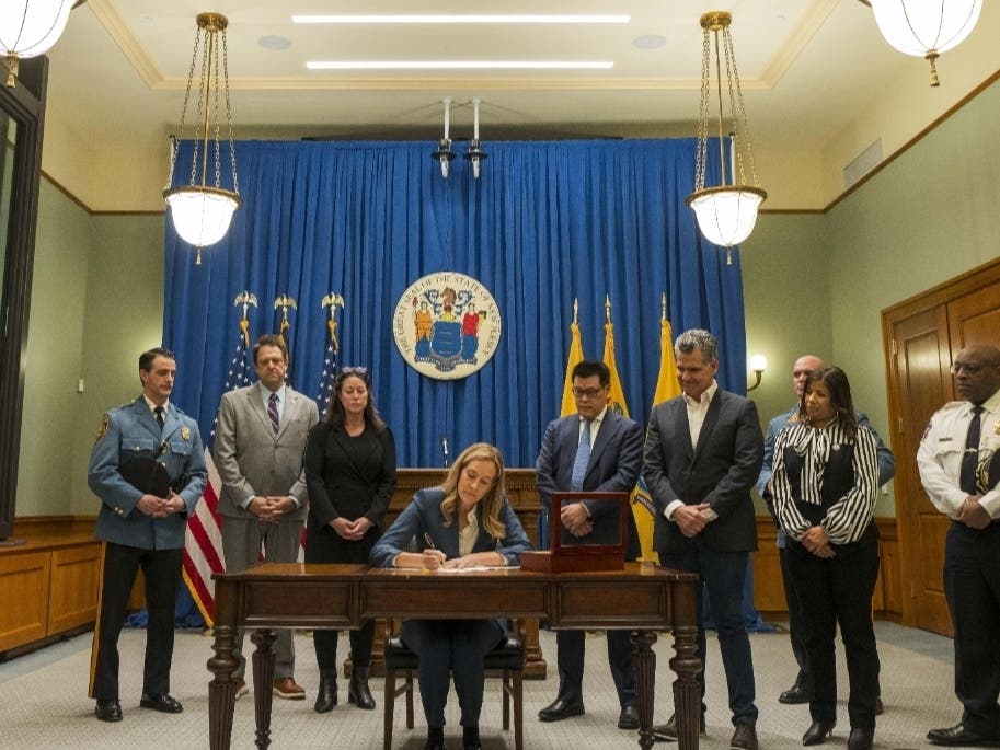 Gov. Mikie Sherrill signs Executive Order 12, prohibiting ICE agents from operating on state-controlled property without a judicial warrant. 