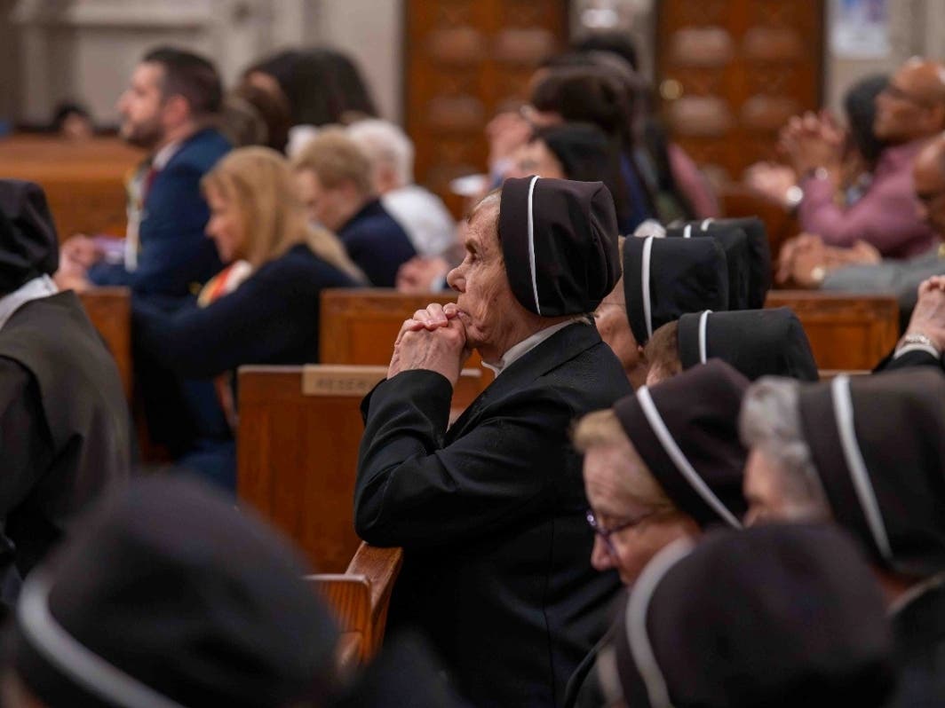The Filippini Sisters pray during the Italian Heritage Mass, which honored their decades of service to the archdiocese.