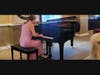 A pianist performs during the Washington International Piano Arts Council's 2025 Winners' Classic Circle event at the Founding Church of Scientology in Washington, DC, delighting the audience with a captivating classical repertoire.