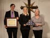 Executives of the Founding Church of Scientology of Washington, DC accept a U.S. flag flown over the Capitol in honor of the Church’s 70th anniversary and its long-standing community service, at the request of Congresswoman Eleanor Holmes Norton.