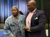 Rasheen Peppers, founder and chief executive officer of the Partnership for West Side High School (right), presents Mae Smith (left) with the Mae Smith Civic Award.