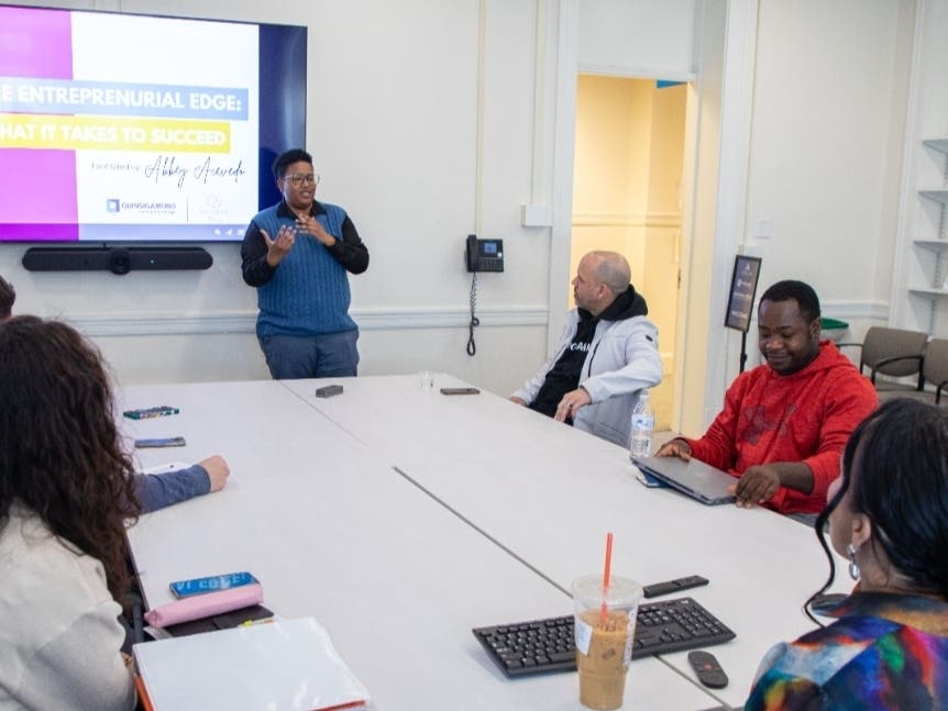 Director Rocky Knight (standing) during a presentation at the Auxilium Center for
Entrepreneurship at QCC.