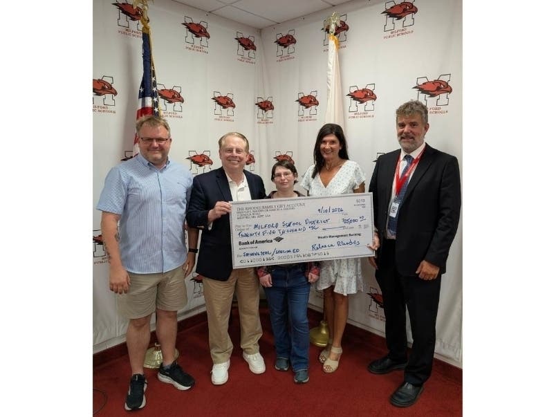 Rebecca Rhodes, a 2006 graduate, presented a $25,000 gift during the  Milford School Committee meeting on Thursday. The donation, made in memory of her mother, is earmarked for the Special Education Department and Shining Star Early Childhood Center.
