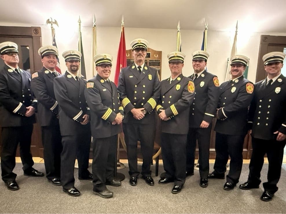 Canton Fire Chief Jamie Meier, center, stands with eight recently promoted firefighters: two deputy chiefs, three captains and three lieutenants.