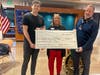 Connor and Vicki Castleman of Desert Hills present a check to the Rotary Club of Anthem