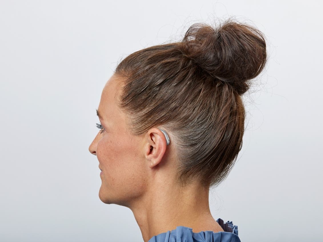 Woman wearing Oticon hearing aid