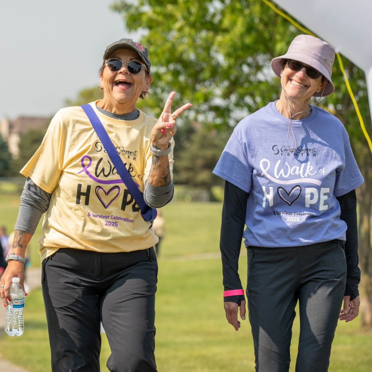 Cancer survivors participate in the Cancer Support Center’s Walk of Hope & Survivor Celebration surrounded by community members showing support and encouragement.