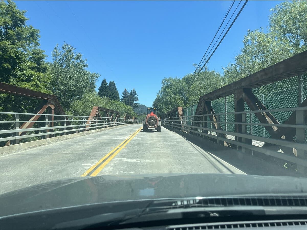 Part of the commute in Healdsburg includes machinery like this one crossing the Westside Road truss bridge.