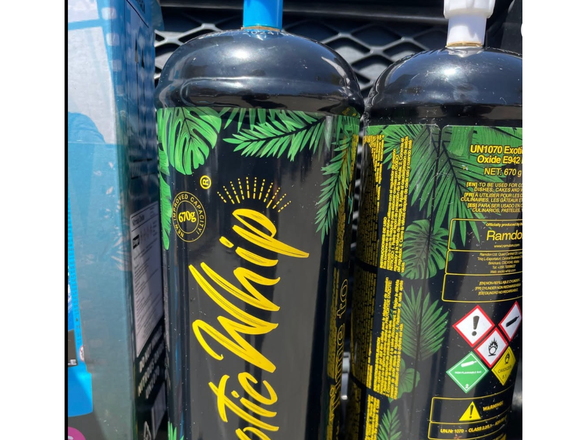 Officers investigating a vehicle found a woman with a dozen nitrous oxide containers and arrested her on suspicion of possessing the gas for inhalation.
