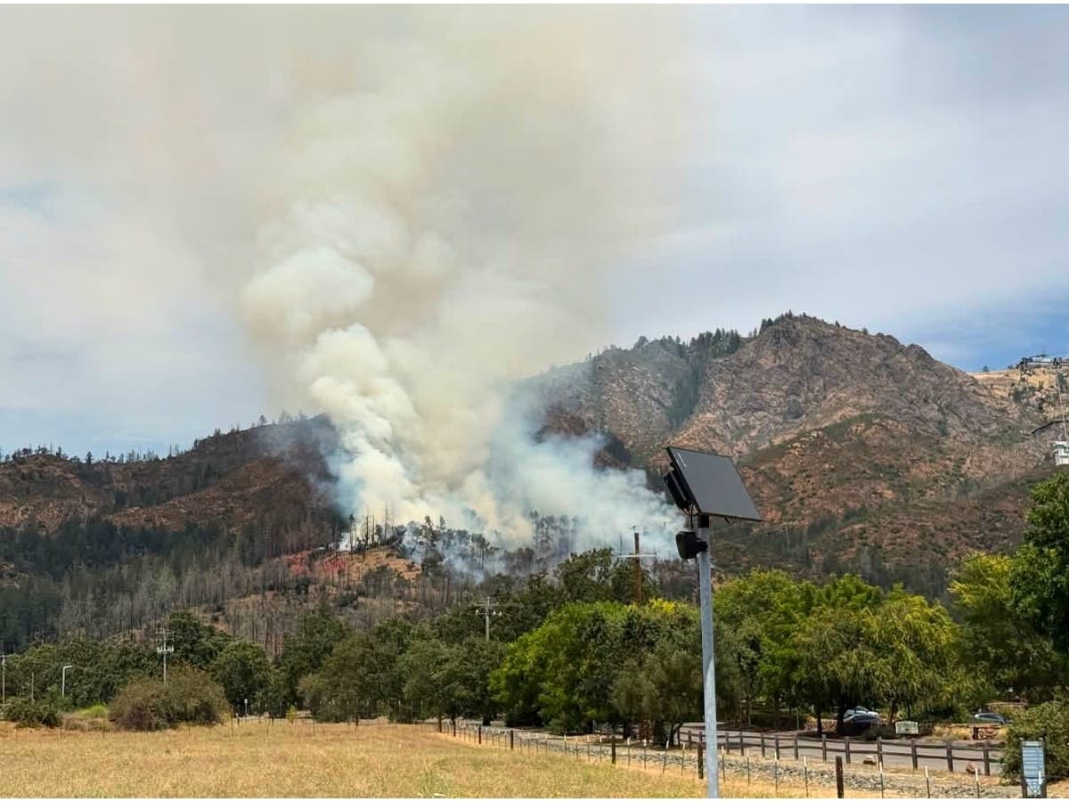 Fire tankers, helicopters, and ground crews continue attacking the wildfire as deputies evacuate nearby residents.