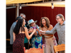 Cassidy Johnston (left) toasts  guests at a dinner party hosted at The Hangout near the Russian River, which she designed to make money from private events while inviting neighbors to gather for free the rest of the week.