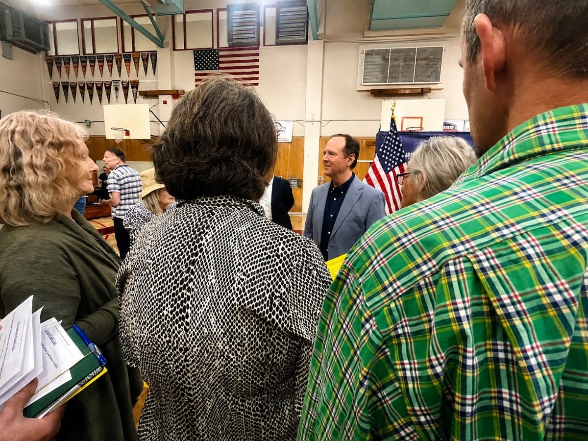 An anxious grandmother’s question to U.S. Sen. Adam Schiff (center, facing forward) and CA Mike McGuire about carrying her birth certificate captured fears about the Nov. 3 election at a packed meeting inside the Piner High School gym on Aug. 12, 2026. 