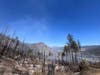 Evacuation orders remained in effect Monday at 6:30 p.m. as firefighters attack lingering heat and authorities inspect the damage.